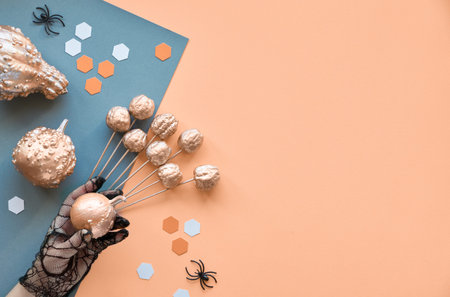 Creative paper craft Halloween background. Flat lay with spiders, pumpkins and hexagons on split...