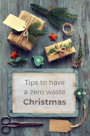 Seasonal background with text "Tips to have zero waste Christmas". Making gifts from natural decorations and recycled crafter paper on rustic wooden table for Xmas day, flat lay.の写真素材