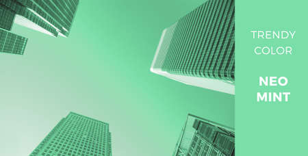 Biscay green - trendy color for 2020, toned image of modern architecture with view from below on glass skyscrapers の写真素材