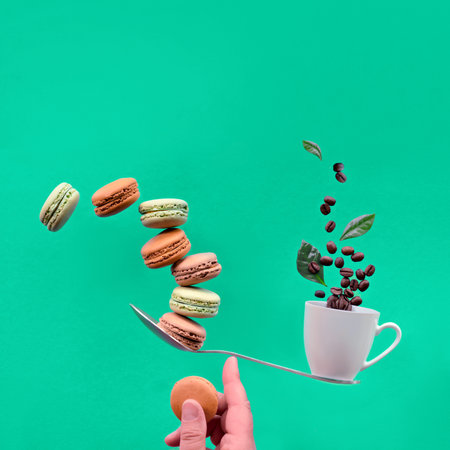 Perfect balance concept. Balancing cup of coffee and macaronos on index finger. Creative square food...
