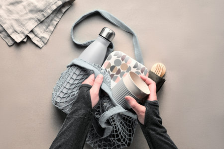 Zero waste packed lunch kit in mesh bag. Net bag with insulated metal water bottle, bamboo cutlery,...