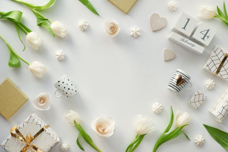 Valentines day flat lay, top view on white background with fresh tulips, coffee cups and sweets,...
