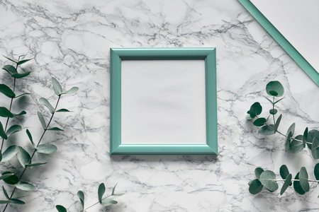 Flat lay, top view eucalyptus on marble background, light textured stone table surface. Trendy...
