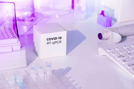 Test kit to detect novel COVID-19 coronavirus in patient samples. RT-PCR kit reagents convert viral Covid19 RNA to DNA and amplify region of viral DNA specific for 2019-nCov. Neon glow, purple light.の写真素材