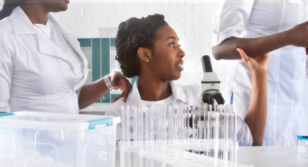 Female African medical students, young graduates or doctors discuss ongoing project. Team working...