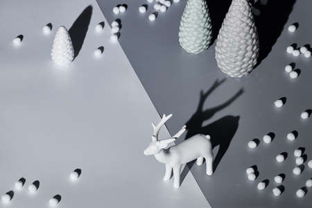 Trendy isometric Christmas arrangement with deer and Xmas trees in monochrome grey. Two tone paper background.Long shadow design. Color two tone paper background, copy-spaceの写真素材