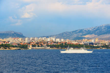 Split City Harbor from upper deck of large sea ferry boat. Sea, passenger ship, city skyline with mountains behindの写真素材