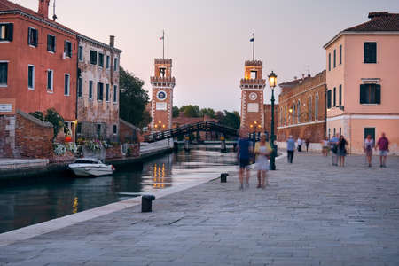 Venice, Italy - September 18, 2020: People walk along canal by Arsenal water gate in Venice, Italy. Venezia during the coronavirus pandemic.のeditorial素材