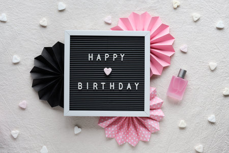 Text Happy Birthday on letter board, letterboard. Creative flat lay, top view on ivory, off white...