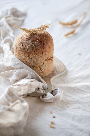 Dinkelbrot in German that means spelt. Loaf of wholemeal dinkel rye bread. Dinkel or Spelt is an...