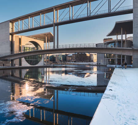 BERLIN, GERMANY - FEBRUARY 14, 2021: Pier Paul-Loebe-Haus Reichstag. Panoramic winter view with snow. Paul-Loebe-Haus connected by bridge with Marie-Elisabeth-Lueders-Haus over Spree river.のeditorial素材