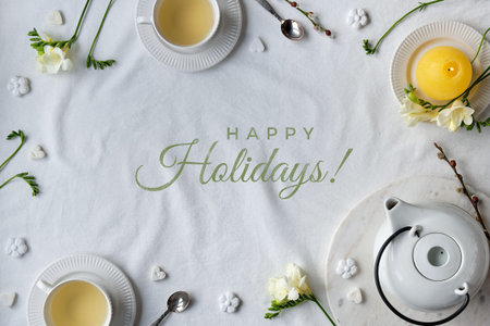 Text Happy Holidays. Springtime background. Spring freesia flowers and tea cup on table. Easter...