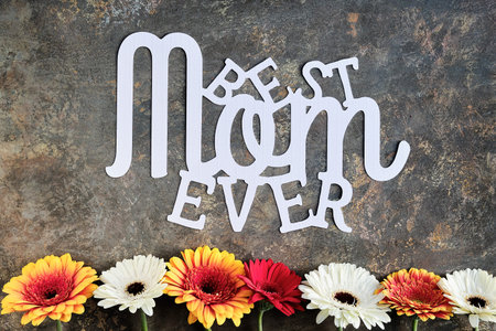 Paper text Best Mom Ever. Greeting card floral design for Mothers day. Gerberas and white baby...