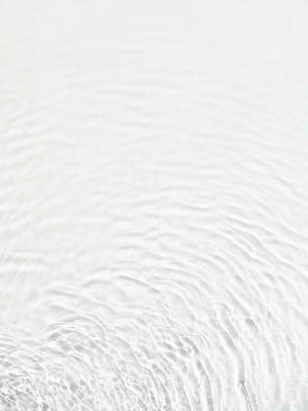 Water background. White water texture, white water surface with rings and ripple. Spa concept background. Flat lay, top view, copy space, copy-space.の写真素材