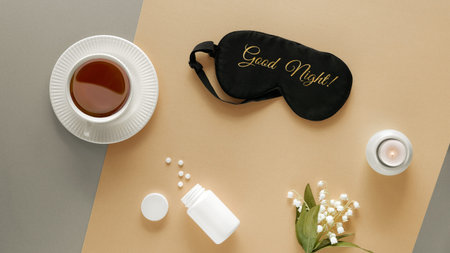 Quality of sleep. Sleep mask, sleeping pills, scented candle and cup of calming tea. Two tone silver...