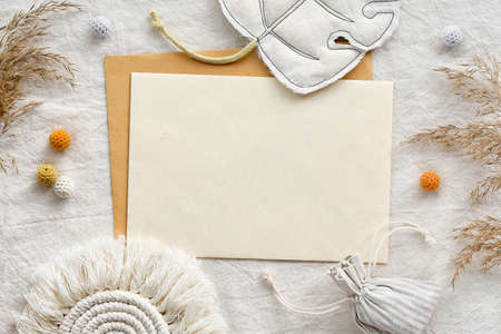 Minimal mockup with off white card, envelope, macrame and pampas grass, reeds.の写真素材