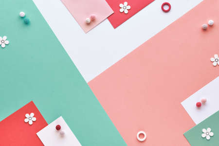 Geometric layered paper background in pink, white and mint green. Decorative cotton balls and wood flowers. Space for your text, copy-space, place for text.の写真素材