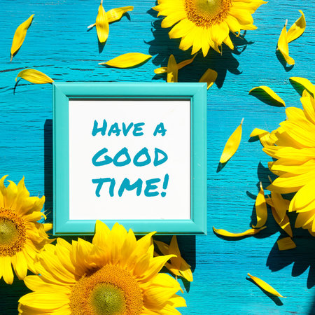 Text Have a Good Time in square white frame. Yellow sunflower flowers and petals scattered on...