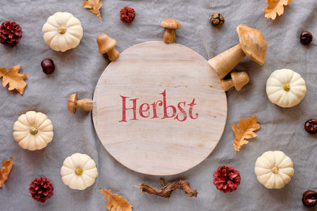 Test Herbst means Autumn in German language. Background with stone circle, natural pumpkins,...