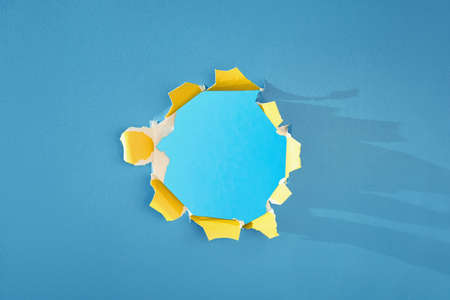 Blue yellow paper hole. Mockup background for your product. Copy-space, place for text.の写真素材