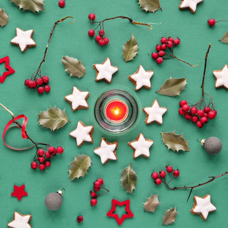 Winter Christmas background in mint green, white and red. Flat lay, hawthorn berry, eucalyptus, Xmas...