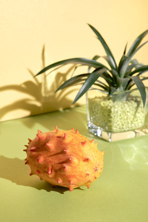 Dragon fruit, pitahaya, close-up on two color paper background. Vibrant golden yellow and orange...