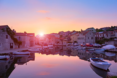 Sunset over Vrboska village, Hvar island, Dalmatia, Croatia, Europe. Travel and vacation destination. Old fisherman village, famous tourist attraction.の写真素材