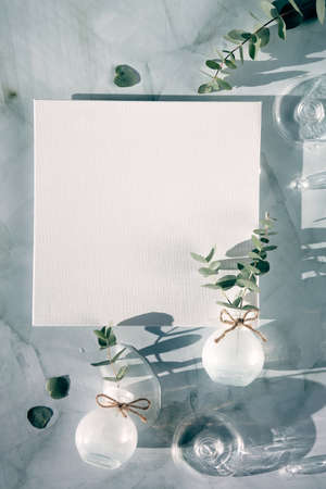 Springtime mockup with blank square canvas and Spring decorations. Fresh eucalyptus twigs in glass vase.の写真素材