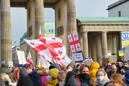 Georgian national flags on anti war protest in German capital. Solidarity of different nations against war in Ukraine.のeditorial素材