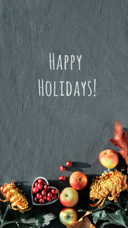 Orange chrysanthemum flowers, dry bunny tail grass and red oak leaves. Autumn decorations, top view with copy-space. Flat lay on dark textile.の写真素材