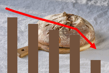 Crisis graph with negative statistics. Background with loaf of dark bread on wood with linen towel.