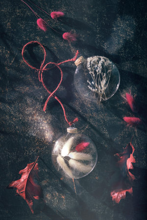 Autumn flat lay with dry grass in glass trinkets, hemp cord, magenta dried bunny tails and oak leavesの写真素材