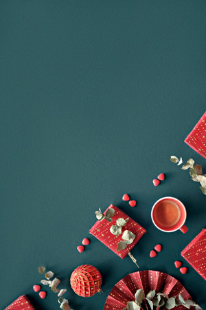 Wintertime magenta decor, gift boxes. Flat lay on dark blue linen textile with copy-space, place for text. Wrapped presents, wrapping paper fan, eucalyptus. Red blue corner arrangement.の写真素材