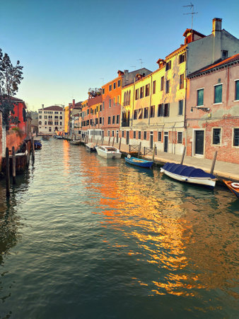 Central Venice, historic houses reflected in canal on a sunset, toned image.の写真素材