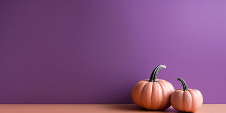 Two small pumpkins sitting on a table in front of a purple wall. Generative AI image.の素材