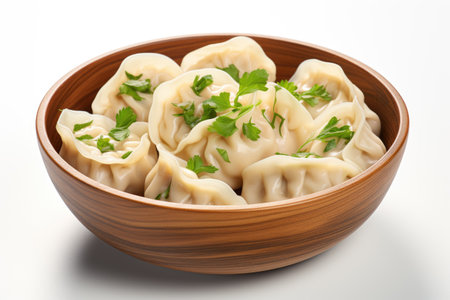 A wooden bowl filled with dumplings and garnished with parsley. Chinese wonton soup.の素材