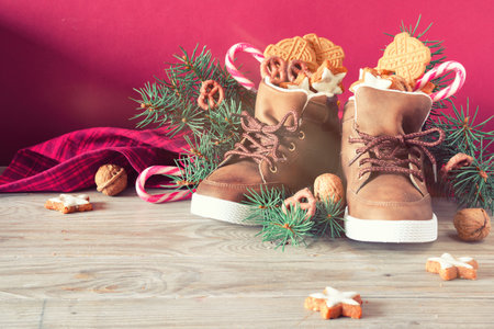 Saint Nicholas Day or Nikolaus. Children shoes filled with traditional sweetsの写真素材