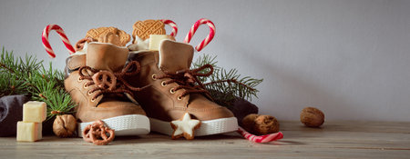 Saint Nicholas Day or Nikolaus. Children shoes filled with traditional sweetsの写真素材