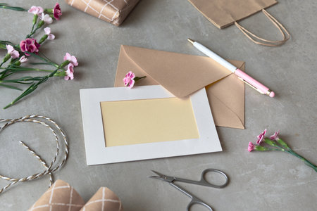 Greeting card concept with envelope and carnation flowers. Copy space for your greeting text.の写真素材