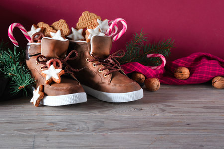 Saint Nicholas Day or Nikolaus. Children shoes filled with traditional sweetsの写真素材