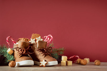 Saint Nicholas Day or Nikolaus. Children shoes filled with traditional sweetsの写真素材