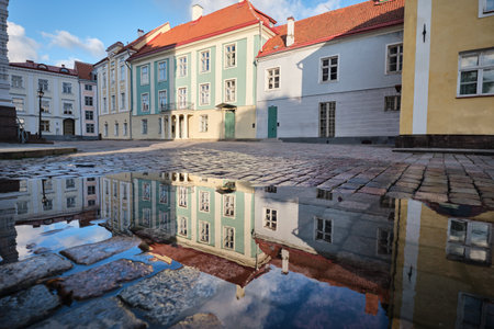 A reflection of a building in a puddle of water, Tallinn city, Estonia.の写真素材