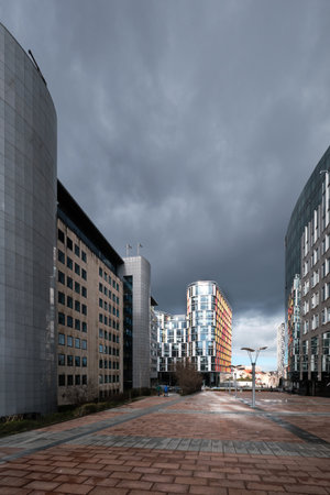 EU headquarters, European commission, offices of European Union in Brussels under stormy dark dramatic sky.のeditorial素材