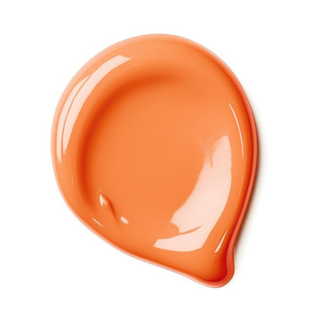 A close up of an orange paint on a white surfaceの素材