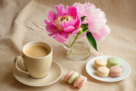 A cup of coffee and some macaroons on a tableの素材