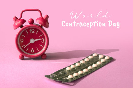 Text World Contraception Day. Alarm clock and a pack of contraceptive pills on pink paper background.の写真素材