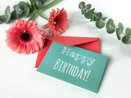 Happy Birthday Card Next to Gerbera Flowerの写真素材