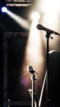 A microphone and some lights in a dark roomの素材