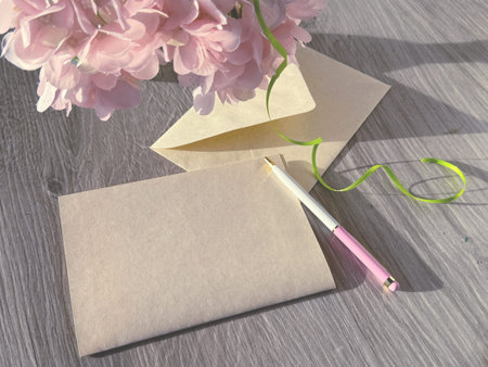 A Vase of Pink Flowers on Top of a Wooden Table. Copy-space on Blank Greeting Card.
