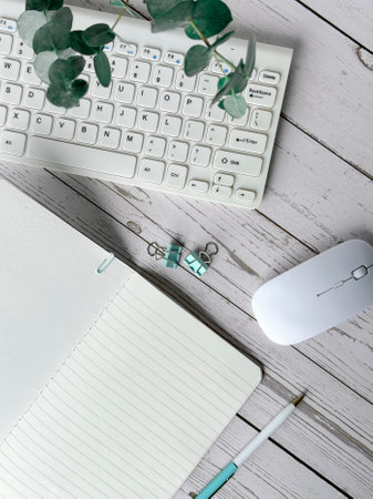 Keyboard, Blank Notebook and Mouse on a Deskの写真素材